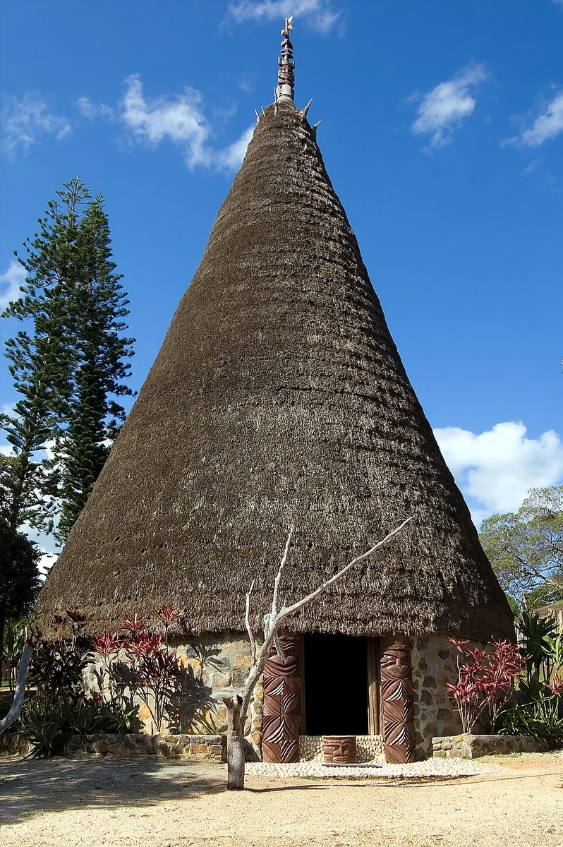 A Kanak house with a carved rooftop finial, or flèche faîtière, at the Tjibaou Cultural Centre in Nouméa.