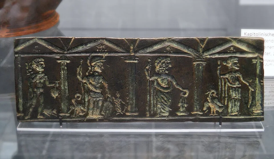 Mercury and the Capitoline Triad—Jupiter, Juno, and Minerva—on a second-century Roman relief in Munich.
